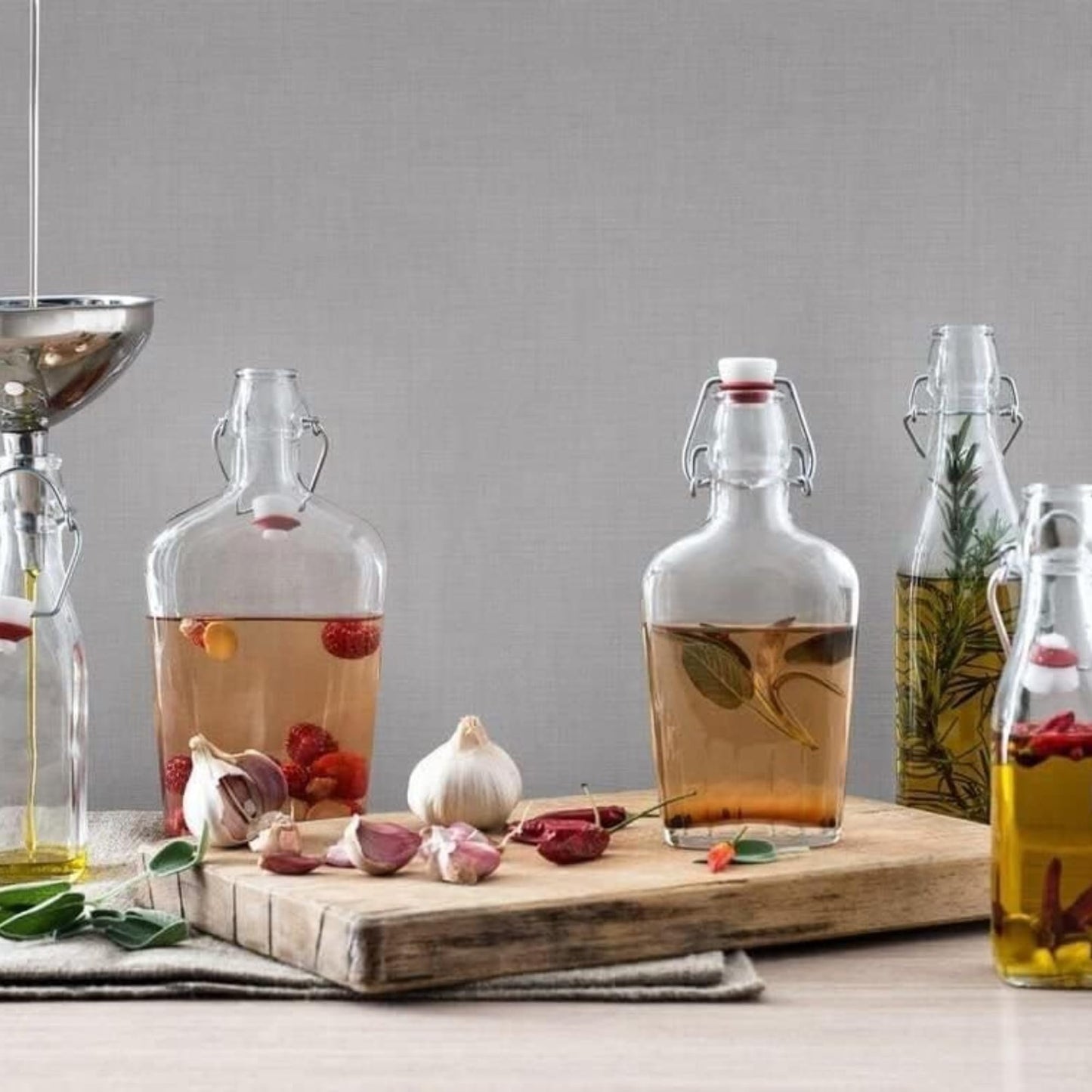 Bormioli Rocco Swing Top Glass Bottle (Set of 4) - Reusable Container with Secure Metal Clasp, Ideal for Homemade Juices, Oil Infusions, Condiments, Mixers - Everyday Drinking Glasses